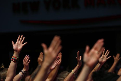 People take part in a group yoga practice on the morning of the summer solstice in New York's Times Square, June 21, 2013. REUTERS/Eric Thay People take part in a group yoga practice on the morning of the summer solstice in New York's Times Square, June 21, 2013. REUTERS/Eric Thay