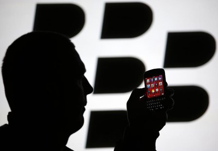 A man is silhouetted against a video screen with the Blackberry logo as he pose with a Blackberry Q10 in this photo illustration taken in th A man is silhouetted against a video screen with the Blackberry logo as he pose with a Blackberry Q10 in this photo illustration taken in th
