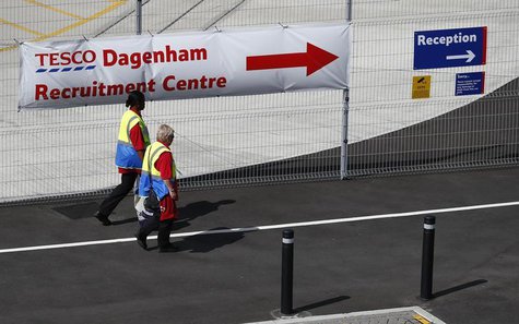 Workers pass a recruitment banner at Tesco's new distribution facility in Dagenham, east London August 12, 2013. REUTERS/Andrew Winning Workers pass a recruitment banner at Tesco's new distribution facility in Dagenham, east London August 12, 2013. REUTERS/Andrew Winning