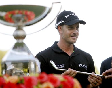 Henrik Stenson of Sweden accepts a replica of a Bobby Jones putter as he stands beside the FedExCup trophy after winning the the Tour Champi Henrik Stenson of Sweden accepts a replica of a Bobby Jones putter as he stands beside the FedExCup trophy after winning the the Tour Champi