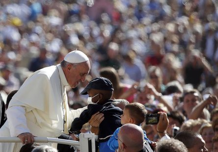 Pope Francis waves to a child as he arrives to lead his Wednesday general audience in Saint Peter's Square at the Vatican September 18, 2013 Pope Francis waves to a child as he arrives to lead his Wednesday general audience in Saint Peter's Square at the Vatican September 18, 2013