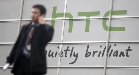 Visitors walk past a HTC sign at the GSMA Mobile World Congress in Barcelona, February 14, 2011. REUTERS/Albert Gea Visitors walk past a HTC sign at the GSMA Mobile World Congress in Barcelona, February 14, 2011. REUTERS/Albert Gea