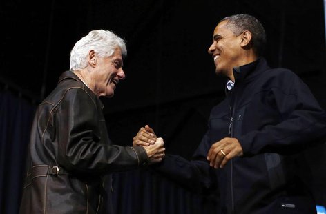 Former U.S. President Bill Clinton (L) introduces U.S. President Barack Obama during a campaign rally in Bristow, Virginia, November 3, 2012 Former U.S. President Bill Clinton (L) introduces U.S. President Barack Obama during a campaign rally in Bristow, Virginia, November 3, 2012