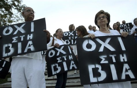 Protesters hold placards during an anti-violence rally following the killing of Greek rapper Pavlos Fissas by a supporter of the far-right G Protesters hold placards during an anti-violence rally following the killing of Greek rapper Pavlos Fissas by a supporter of the far-right G