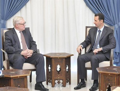 Syria's President Bashar al-Assad (R) meets Russian deputy Foreign Minister Sergei Ryabkov in Damascus, in this handout photograph distribut Syria's President Bashar al-Assad (R) meets Russian deputy Foreign Minister Sergei Ryabkov in Damascus, in this handout photograph distribut