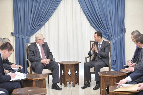 Syria's President Bashar al-Assad (centre, on R) meets Russian deputy Foreign Minister Sergei Ryabkov (centre, on L) in Damascus, in this ha Syria's President Bashar al-Assad (centre, on R) meets Russian deputy Foreign Minister Sergei Ryabkov (centre, on L) in Damascus, in this ha