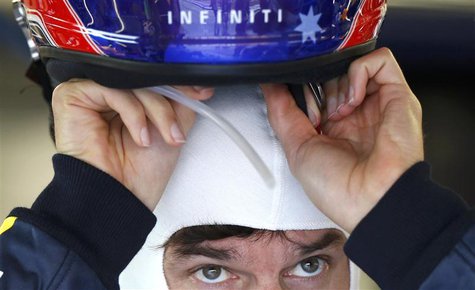 Red Bull Formula One driver Mark Webber of Australia handles his helmet in the team's garage during the third practice session of the Singap Red Bull Formula One driver Mark Webber of Australia handles his helmet in the team's garage during the third practice session of the Singap