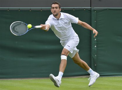 Marin Cilic of Croatia hits a return to Marcos Baghdatis of Cyprus in their men's singles tennis match at the Wimbledon Tennis Championships Marin Cilic of Croatia hits a return to Marcos Baghdatis of Cyprus in their men's singles tennis match at the Wimbledon Tennis Championships