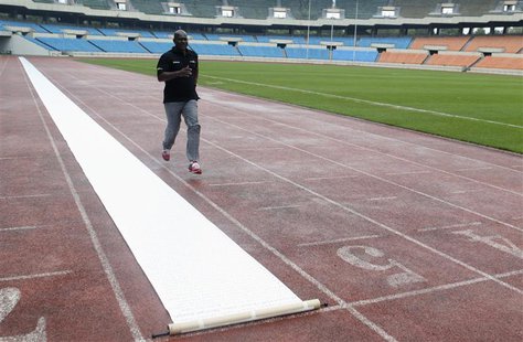 Sprinter Ben Johnson of Canada runs next to a scroll petition laid out on the track at the Seoul Olympic Stadium in Seoul September 24, 2013 Sprinter Ben Johnson of Canada runs next to a scroll petition laid out on the track at the Seoul Olympic Stadium in Seoul September 24, 2013