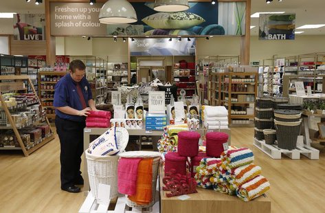 An employee straightens a display in the home ware department at a Tesco Extra supermarket in Watford, north of London August 8, 2013. REUTE An employee straightens a display in the home ware department at a Tesco Extra supermarket in Watford, north of London August 8, 2013. REUTE