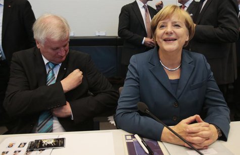 Bavarian state Premier Horst Seehofer and German Chancellor Angela Merkel await the start of a parliamentary group meeting of the Chirstian Bavarian state Premier Horst Seehofer and German Chancellor Angela Merkel await the start of a parliamentary group meeting of the Chirstian
