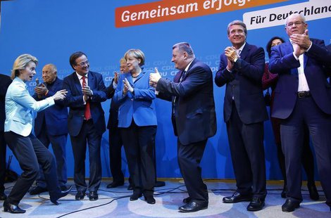 German Chancellor and leader of the Christian Democratic Union (CDU) Angela Merkel (C) and CDU party fellows sing as they celebrate after fi German Chancellor and leader of the Christian Democratic Union (CDU) Angela Merkel (C) and CDU party fellows sing as they celebrate after fi
