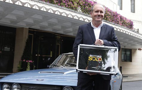 Author William Boyd poses for photographers with one of the first copies of his new James Bond book 'Solo,' in front of a Jensen car outside Author William Boyd poses for photographers with one of the first copies of his new James Bond book 'Solo,' in front of a Jensen car outside