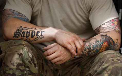 A soldier from the U.S. Army's 1st Platoon, 18th Engineer Company, Task Force Arrowhead rests at Forward Operating Base Mizan after completi A soldier from the U.S. Army's 1st Platoon, 18th Engineer Company, Task Force Arrowhead rests at Forward Operating Base Mizan after completi