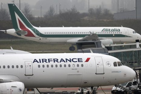 An Alitalia plane passes an Air France plane on the tarmac of Charles de Gaulles International Airport in Roissy near Paris, January 8, 2013 An Alitalia plane passes an Air France plane on the tarmac of Charles de Gaulles International Airport in Roissy near Paris, January 8, 2013