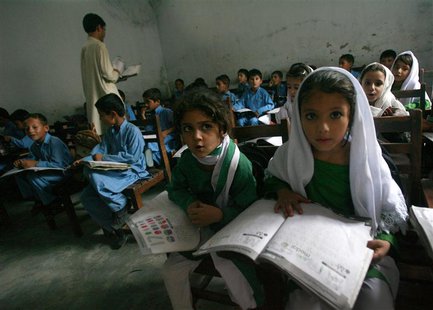 Female students Shaista (R), 12, and Rabia (L), 10, read aloud while taking part in class in Buner district about 220 km (137 miles) by road Female students Shaista (R), 12, and Rabia (L), 10, read aloud while taking part in class in Buner district about 220 km (137 miles) by road