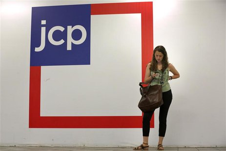 A woman checks her phone outside the entrance of a J.C. Penney store in New York in this file photo August 14, 2013. REUTERS/Brendan McDermi A woman checks her phone outside the entrance of a J.C. Penney store in New York in this file photo August 14, 2013. REUTERS/Brendan McDermi