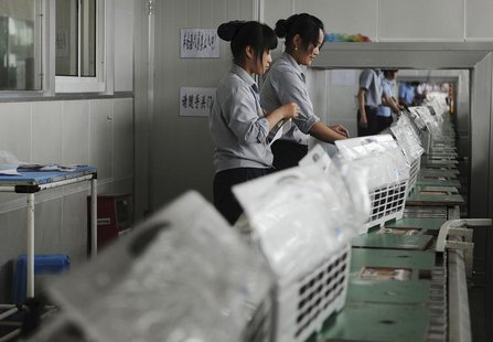 Employees make air-conditioners along a production line at a factory of Gree Electric Appliances in Hefei, Anhui province August 6, 2011. RE Employees make air-conditioners along a production line at a factory of Gree Electric Appliances in Hefei, Anhui province August 6, 2011. RE