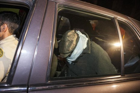 Nakoula Basseley Nakoula (R) is escorted in a Los Angeles County Sheriff's vehicle from his home by officers in Cerritos, California Septemb Nakoula Basseley Nakoula (R) is escorted in a Los Angeles County Sheriff's vehicle from his home by officers in Cerritos, California Septemb