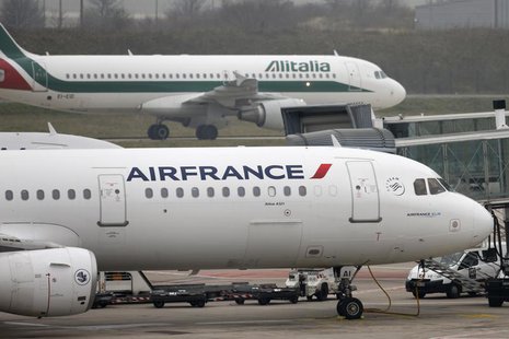 An Alitalia plane passes an Air France plane on the tarmac of Charles de Gaulles International Airport in Roissy near Paris, January 8, 2013 An Alitalia plane passes an Air France plane on the tarmac of Charles de Gaulles International Airport in Roissy near Paris, January 8, 2013