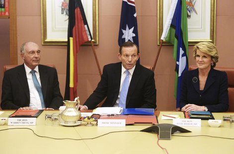 Australia's new conservative Prime Minister Tony Abbott (C) sits between his Foreign Minister Julie Bishop (R) and deputy Prime Minister, Wa Australia's new conservative Prime Minister Tony Abbott (C) sits between his Foreign Minister Julie Bishop (R) and deputy Prime Minister, Wa