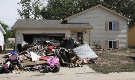 The contents of a home damaged by a flood is seen in the driveway, in Evans, Colorado September 23, 2013. REUTERS/Rick Wilking The contents of a home damaged by a flood is seen in the driveway, in Evans, Colorado September 23, 2013. REUTERS/Rick Wilking