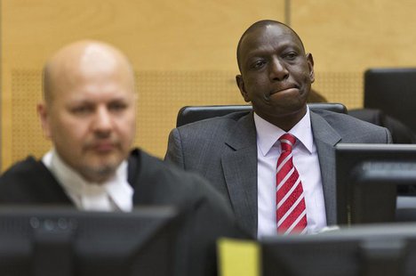 Kenya's Deputy President William Ruto (R) reacts as he sits in the courtroom before his trial at the International Criminal Court (ICC) in T Kenya's Deputy President William Ruto (R) reacts as he sits in the courtroom before his trial at the International Criminal Court (ICC) in T