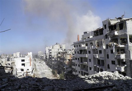 Smoke rises from buildings after what activists say was an air strike by forces loyal to Syrian President Bashar Al-Assad in Homs September Smoke rises from buildings after what activists say was an air strike by forces loyal to Syrian President Bashar Al-Assad in Homs September