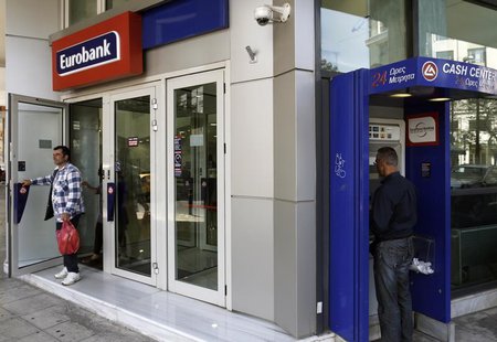 A customer leaves a Eurobank branch in Athens April 10, 2013. REUTERS/John Kolesidis A customer leaves a Eurobank branch in Athens April 10, 2013. REUTERS/John Kolesidis