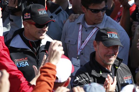 Oracle Team USA Skipper James Spithill (L) and Oracle CEO Larry Ellison walk pass spectators after the team successfully defended the 34th A Oracle Team USA Skipper James Spithill (L) and Oracle CEO Larry Ellison walk pass spectators after the team successfully defended the 34th A