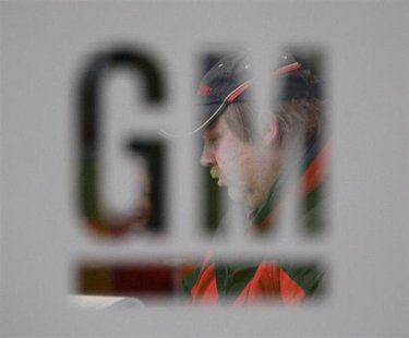 A worker walks behind a logo of General Motors after the announcement of the closing of the Opel assembly plant in Antwerp January 21, 2010. A worker walks behind a logo of General Motors after the announcement of the closing of the Opel assembly plant in Antwerp January 21, 2010.