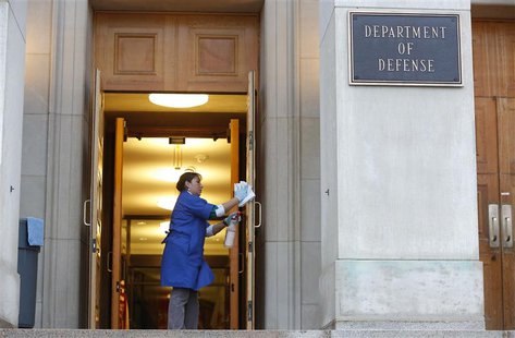 A worker cleans the entryway prior to former U.S. Senator Chuck Hagel's (R-NE) arrival for his first day as Secretary of Defense at the Pent A worker cleans the entryway prior to former U.S. Senator Chuck Hagel's (R-NE) arrival for his first day as Secretary of Defense at the Pent