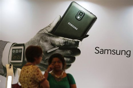 Women stand in front of an ad during the launch of the Samsung Galaxy Note 3 and Galaxy Gear in Jakarta, September 26, 2013. REUTERS/Beawiha Women stand in front of an ad during the launch of the Samsung Galaxy Note 3 and Galaxy Gear in Jakarta, September 26, 2013. REUTERS/Beawiha