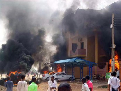 Cars burn in front of a building during protests over fuel subsidy cuts in Khartoum September 25, 2013. REUTERS/Stringer Cars burn in front of a building during protests over fuel subsidy cuts in Khartoum September 25, 2013. REUTERS/Stringer