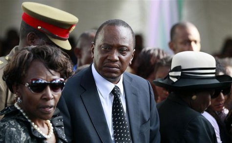 Kenyan President Uhuru Kenyatta (C) joins his relatives as he attends the burial of his nephew Mbugua Maina and Maina's fiancee Rosemary Wah Kenyan President Uhuru Kenyatta (C) joins his relatives as he attends the burial of his nephew Mbugua Maina and Maina's fiancee Rosemary Wah