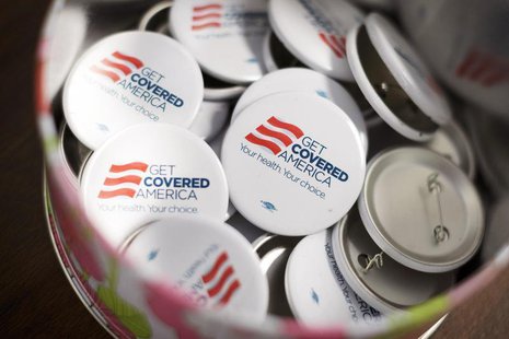 Get Covered America buttons are seen during a training session in Chicago, Illinois September 7, 2013 before volunteers canvas a Chicago nei Get Covered America buttons are seen during a training session in Chicago, Illinois September 7, 2013 before volunteers canvas a Chicago nei