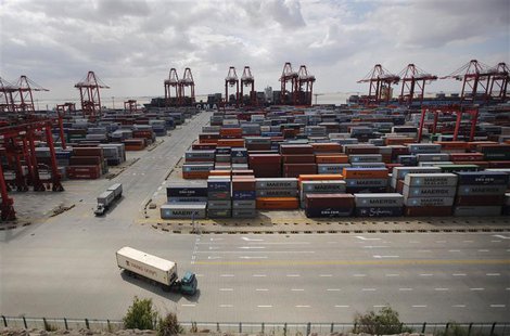 Container trucks drive past the container area at the Yangshan Deep Water Port, part of the newly announced Shanghai Free Trade Zone, south Container trucks drive past the container area at the Yangshan Deep Water Port, part of the newly announced Shanghai Free Trade Zone, south