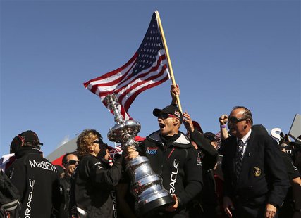 Skipper James Spithill celebrates with the America's Cup with members of the Oracle Team USA after winning the overall title of the 34th Ame Skipper James Spithill celebrates with the America's Cup with members of the Oracle Team USA after winning the overall title of the 34th Ame