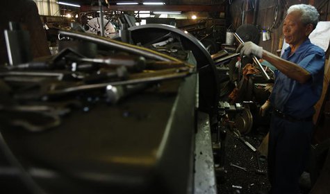 A man works inside a factory in Tokyo August 12, 2013. REUTERS/Yuya Shino A man works inside a factory in Tokyo August 12, 2013. REUTERS/Yuya Shino