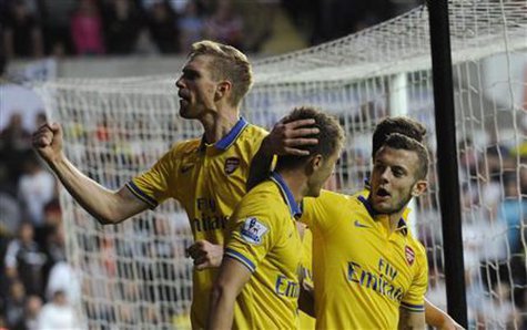 Arsenal's captain Per Mertesacker (L) celebrates the goal of Aaron Ramsey (C) with Jack Wilshere during their English Premier League soccer match at the Liberty Stadium, Swansea, Wales September 28, 2013. REUTERS/Rebecca Naden Arsenal's captain Per Mertesacker (L) celebrates the goal of Aaron Ramsey (C) with Jack Wilshere during their English Premier League soccer match at the Liberty Stadium, Swansea, Wales September 28, 2013. REUTERS/Rebecca Naden