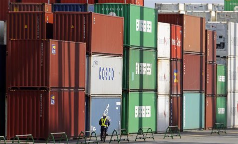 A man rides a bicycle past containers at a port in Tokyo August 19, 2013. REUTERS/Toru Hanai A man rides a bicycle past containers at a port in Tokyo August 19, 2013. REUTERS/Toru Hanai