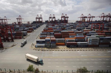 Container trucks drive past the container area at the Yangshan Deep Water Port, part of the newly announced Shanghai Free Trade Zone, south Container trucks drive past the container area at the Yangshan Deep Water Port, part of the newly announced Shanghai Free Trade Zone, south
