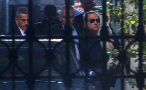 People of Freedom party (PDL) leader Silvio Berlusconi carries his pet dog as he alights from a car upon arriving at his residence in Rome i People of Freedom party (PDL) leader Silvio Berlusconi carries his pet dog as he alights from a car upon arriving at his residence in Rome i
