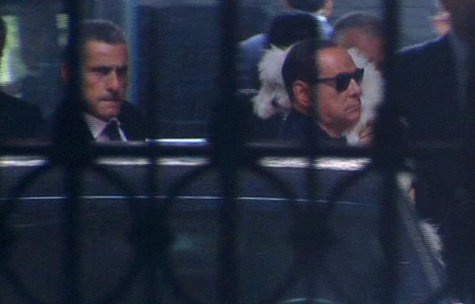 People of Freedom party (PDL) leader Silvio Berlusconi (R) carries his pet dog upon arriving at his residence in Rome in this still image ta People of Freedom party (PDL) leader Silvio Berlusconi (R) carries his pet dog upon arriving at his residence in Rome in this still image ta