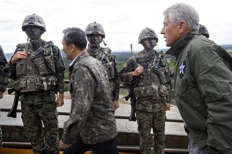 U.S. Secretary of Defense Chuck Hagel (R) walks past South Korean soldiers with South Korea's Defence Minister Kim Kwan-jin (2nd L) during a U.S. Secretary of Defense Chuck Hagel (R) walks past South Korean soldiers with South Korea's Defence Minister Kim Kwan-jin (2nd L) during a