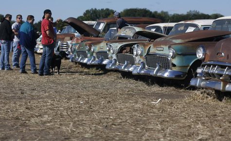 Potential buyers and car enthusiasts check out 1950s era Chevrolet sedans, part of the vintage automobiles from the Lambrecht Collection put Potential buyers and car enthusiasts check out 1950s era Chevrolet sedans, part of the vintage automobiles from the Lambrecht Collection put
