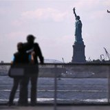 Tourists pause to view the Statue of Liberty from a Liberty Island ferry boat at Battery Park in New York, September 30, 2013. REUTERS/Mike Tourists pause to view the Statue of Liberty from a Liberty Island ferry boat at Battery Park in New York, September 30, 2013. REUTERS/Mike