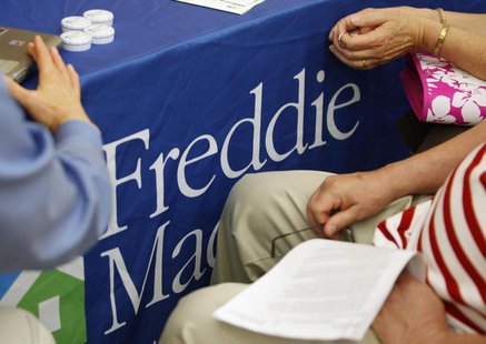 A couple listens as a representative from Freddie Mac talks to them about a loan modification for their home at the National Urban League's A couple listens as a representative from Freddie Mac talks to them about a loan modification for their home at the National Urban League's