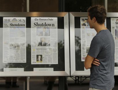A man reads morning newspapers from around the U.S. at the Newseum in Washington October 1, 2013. REUTERS/Gary Cameron A man reads morning newspapers from around the U.S. at the Newseum in Washington October 1, 2013. REUTERS/Gary Cameron