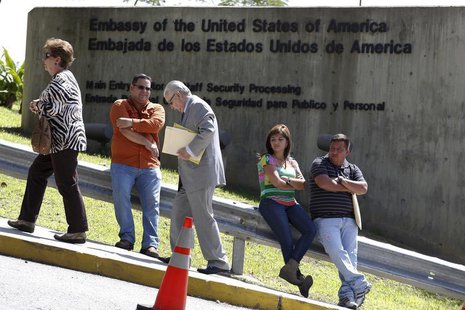 Pedestrians walk past a wall outside the U.S. embassy in Caracas October 1, 2013. REUTERS/Carlos Garcia Rawlins Pedestrians walk past a wall outside the U.S. embassy in Caracas October 1, 2013. REUTERS/Carlos Garcia Rawlins